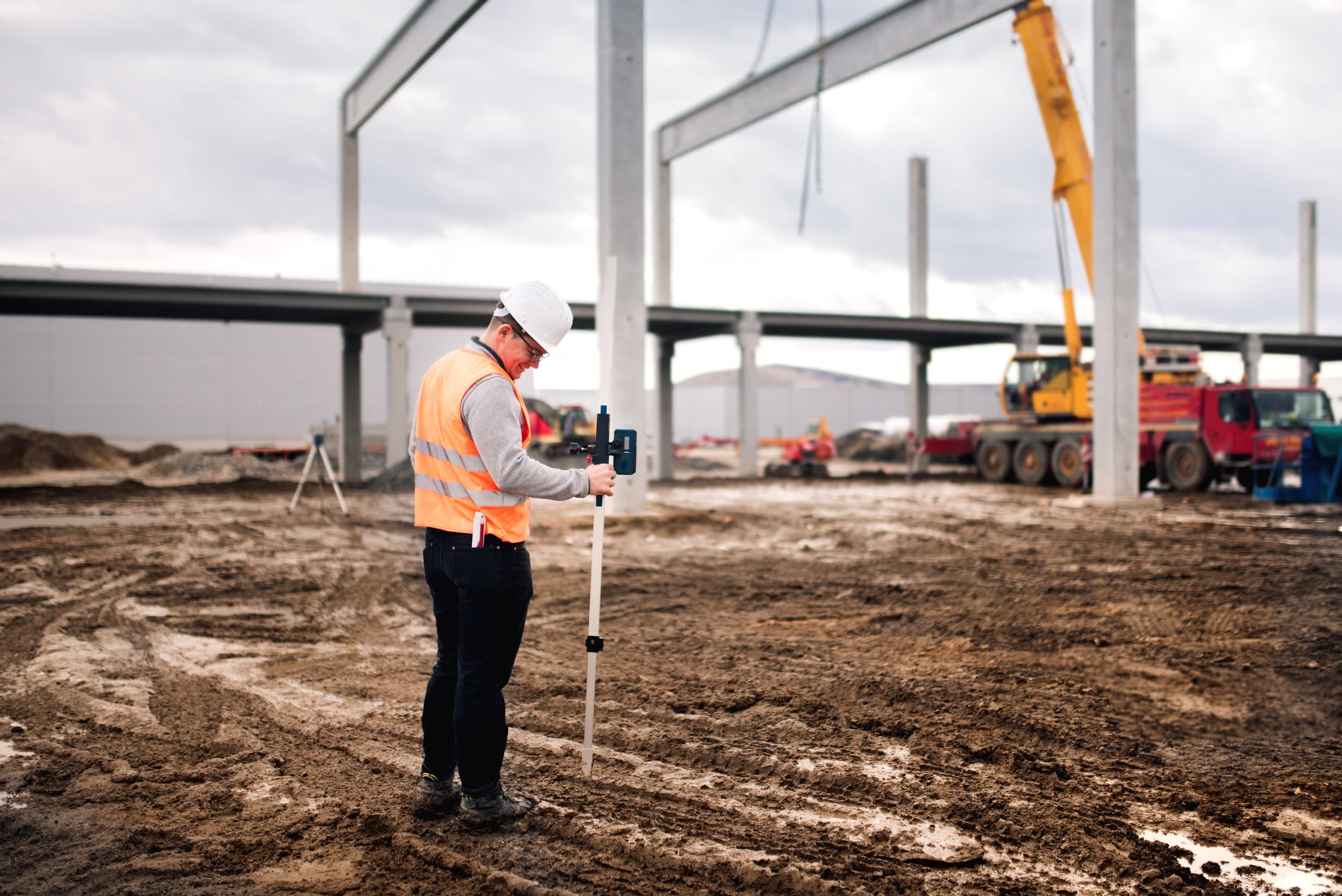 a man in a hard hat holding a level tool