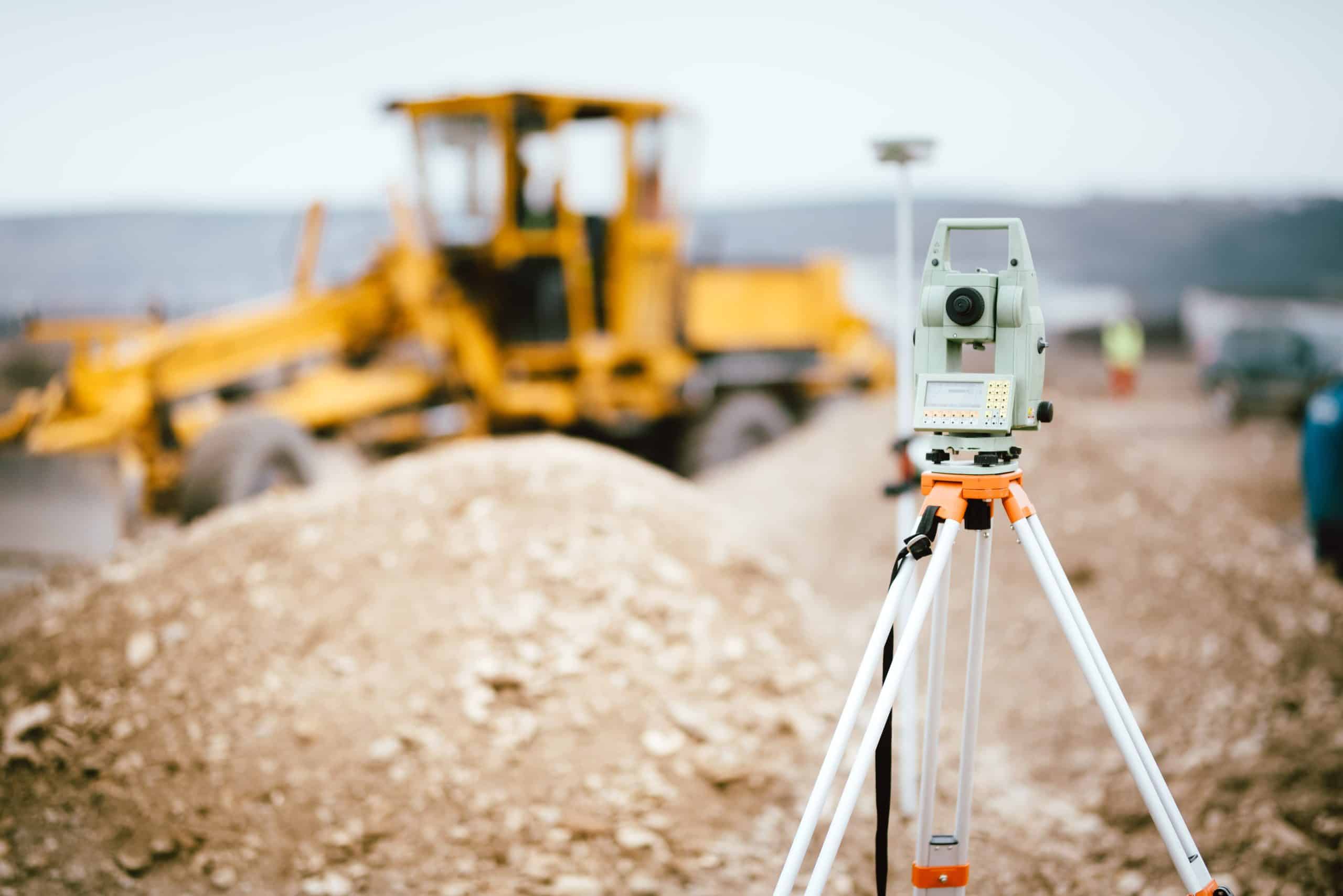 a tripod with a machine in the background