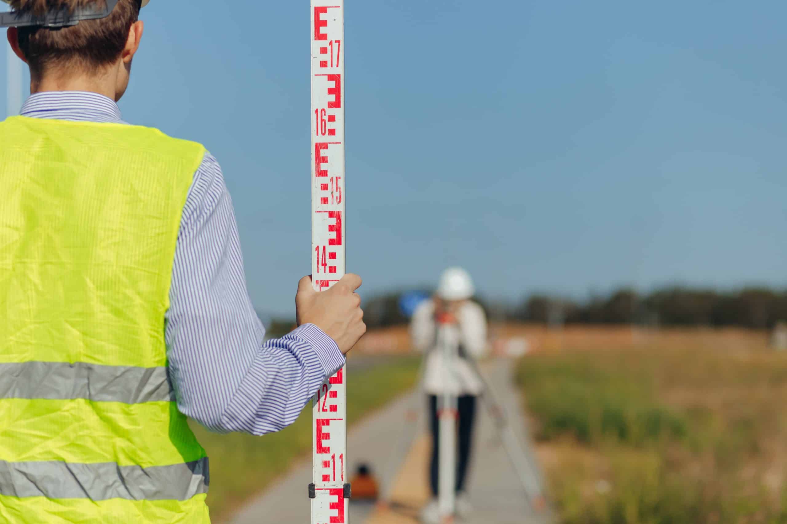 a man holding a ruler